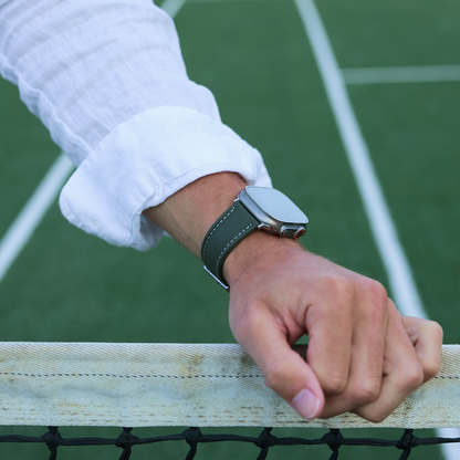 Man wearing The Helm Olive Green Sailcloth Apple Watch Strap at a tennis court