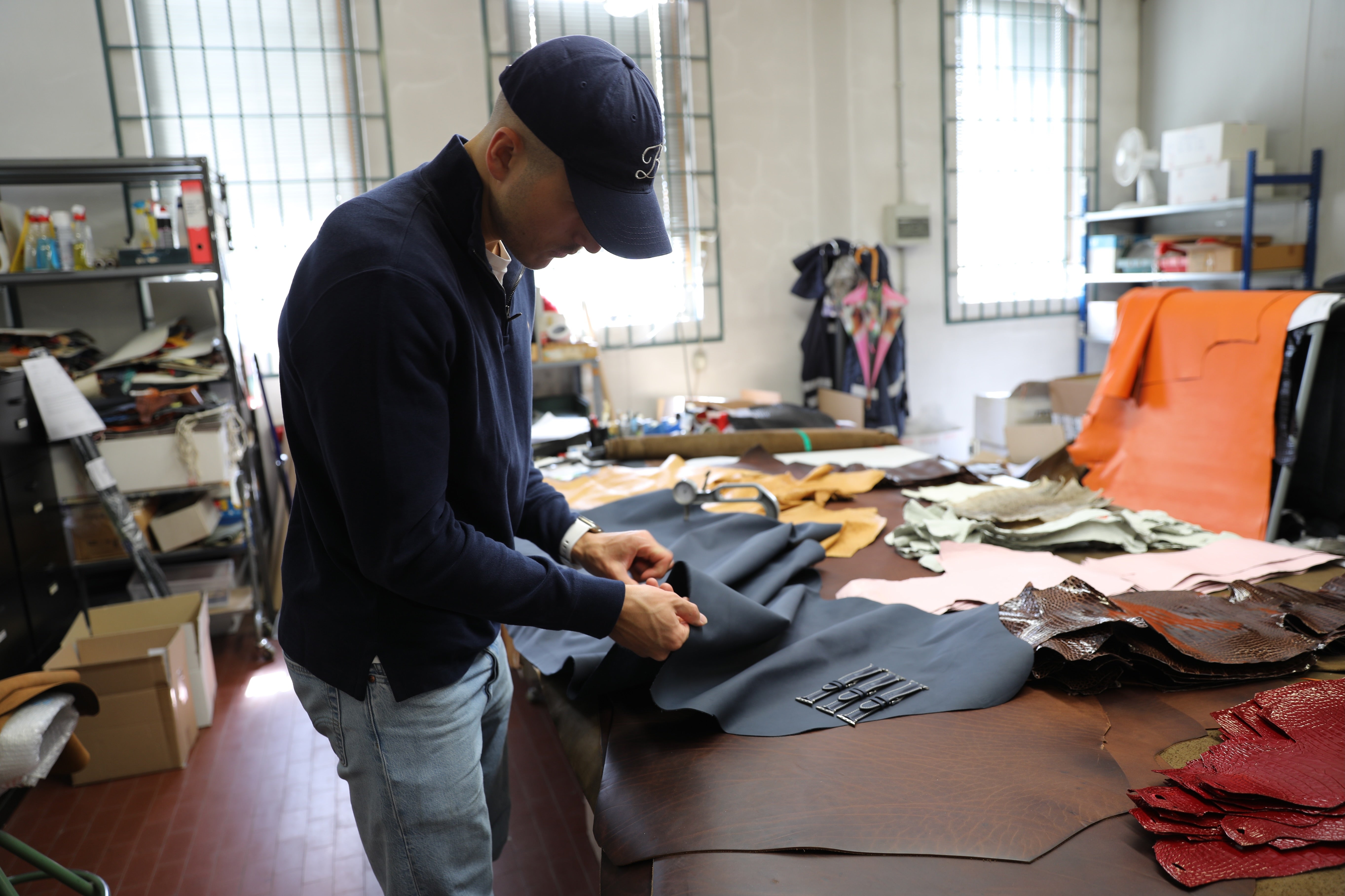 Person working with leather in a workshop setting