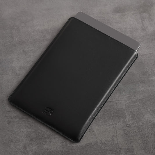 Black leather MacBook sleeve with The Bridge passport sleeve as companion, angled view – The Bridge