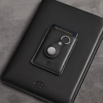Black leather MacBook sleeve and passport sleeve shown with AirTag keychain holder – The Bridge