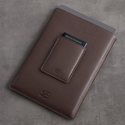 Brown leather MacBook sleeve and passport sleeve shown together as an ecosystem, angled view – The Bridge