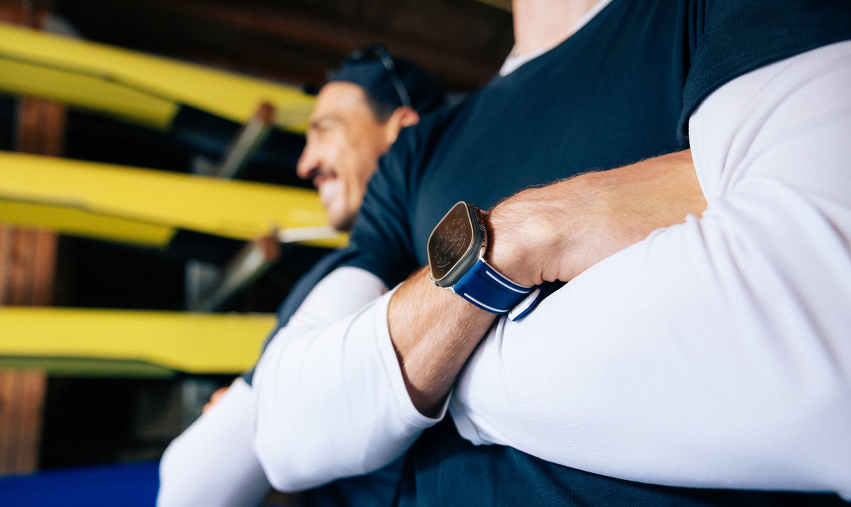 Rower with arms crossed wearing The Henley Apple Watch strap in blue