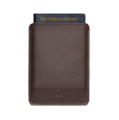 Brown leather passport sleeve by The Bridge with British passport partially inserted, front view