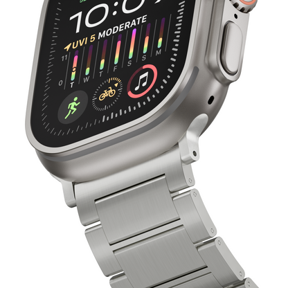 Close-up of a silver smartwatch with a matching metal link band, shown at an angle against a plain white background. The watch face displays a dark watch face with colorful activity rings and icons.