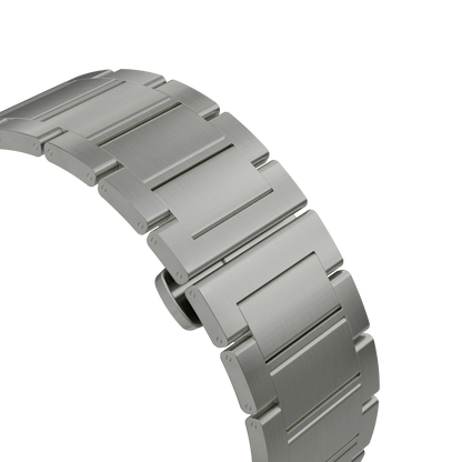 Close-up of a brushed stainless steel watch band with rectangular links, shown on a plain white background.