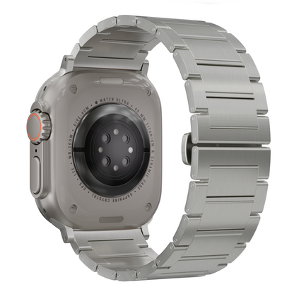 A brushed silver metal link watch band attached to a smartwatch, shown from the back on a clean white background.