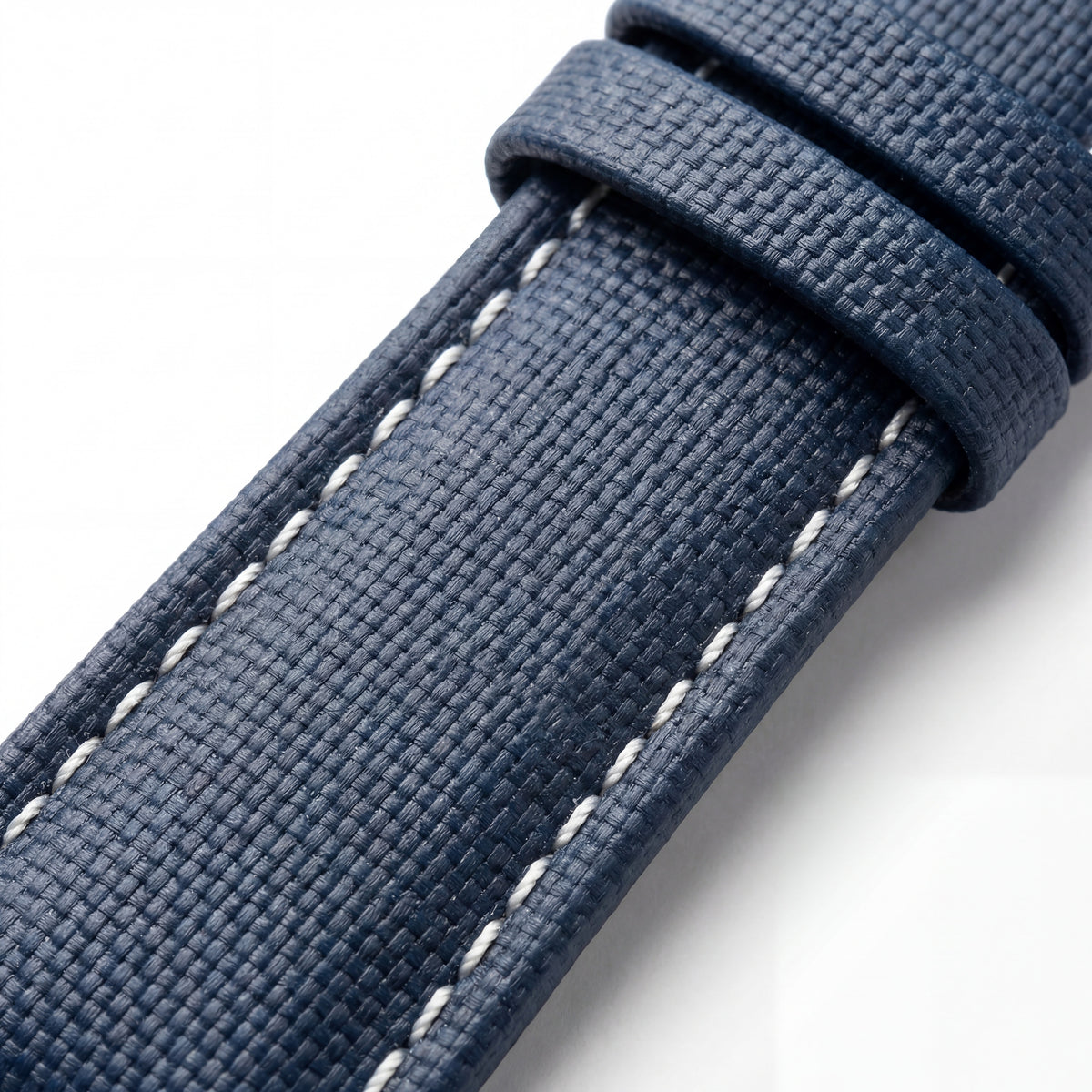 Close-up of The Helm sailcloth Apple Watch strap with contrast stitching