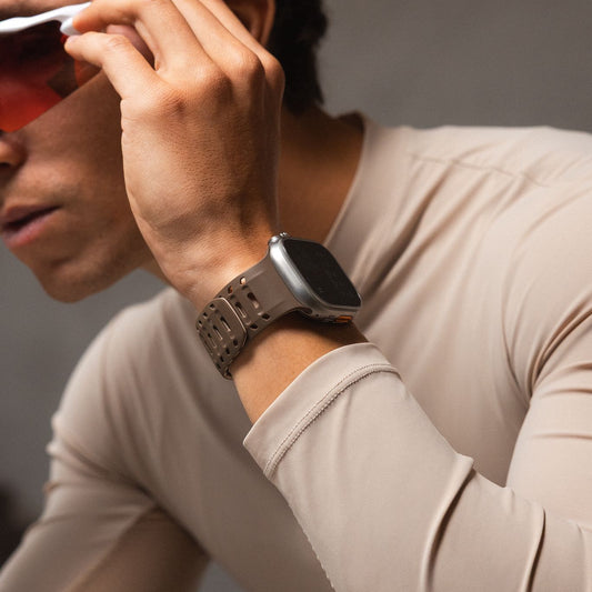 Person wearing an Apple Watch strap with a neutral background